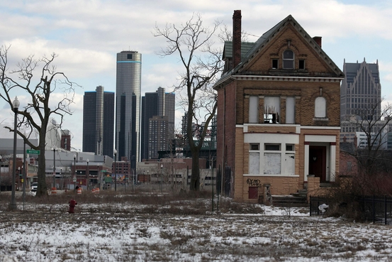 A vacant, boarded up house is seen in the once thriving Brush Park neighborhood with the downtown Detroit skyline behind it in Detroit, Michigan March 3, 2013.